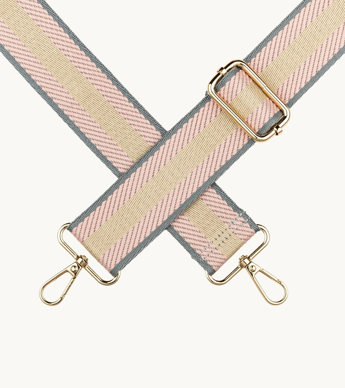 Detail pásikavého crossbody popruhu na mobil Strappy Retro Pastel Pink v ružovej, krémovej a šedej farebnej kombinácii.