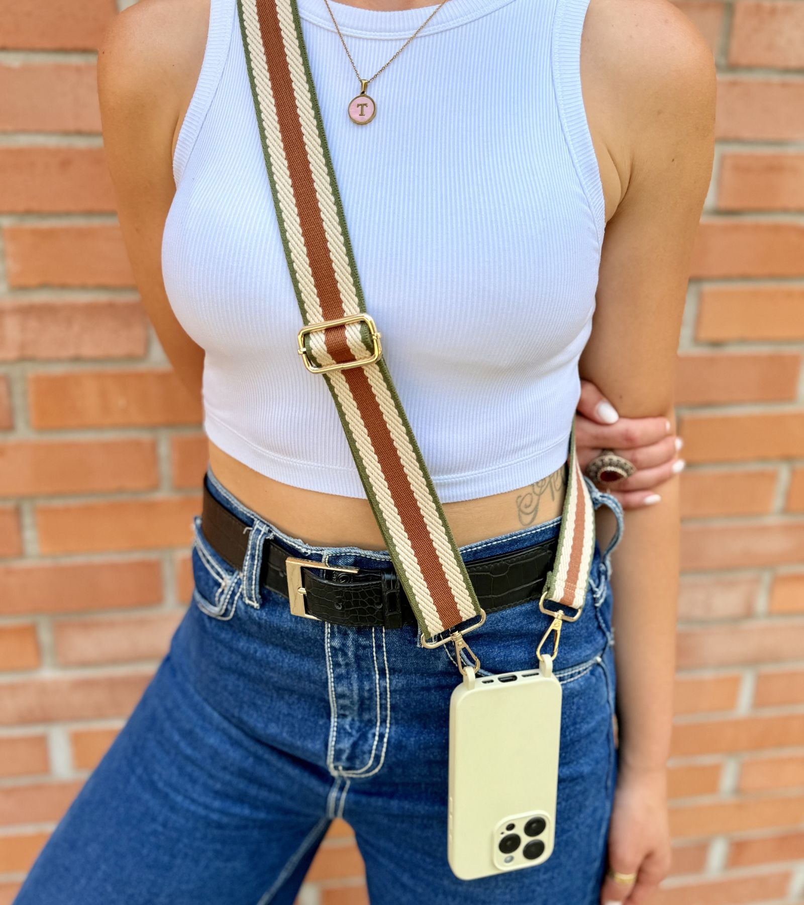 Strappy Set Retro Vintage Brown na modelke – retro pásikavý crossbody popruh na mobil v hnedej farebnej kombinácii a béžový kryt na iPhone pre každodenné nosenie.